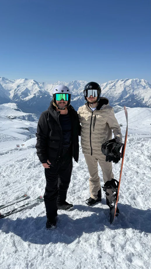Alex Agius and a friend in ski gear on a snowy summit